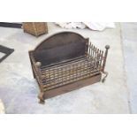 A substantial 19th Century style cast iron fire basket With an arched back plate raised on two