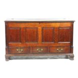 An 18th Century oak mule chest The rectangular hinged top above four invert moulded panels and a