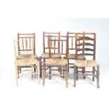 Four 18th/19th Century elm rush seat country chairs Each with a rail back above three turned