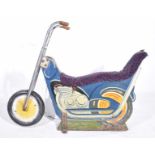 A vintage mid 20th Century fairground motorcycle The chopper motorcycle with plush extended seat