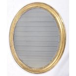 A Regency style giltwood wall mirror Of oval form the reeded exterior frame extending to a relief