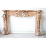 A Continental style carved hardwood fire surround Profusely carved with C scroll brackets and a