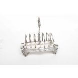 A Victorian Silver toast rack The seven division rack raised on accanthus pierced supports,