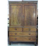 A mid 19th Century mahogany linen press With a plain frieze above a pair of panelled doors