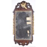 A Regency fretwork style mirror The oxidized plain mirror plate set within scrolling acanthus upper
