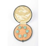 A cased set of six buttons With green marbled cabochon detail to a rose metal trim,