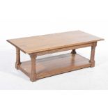 A contemporary light oak coffee table The rectangular moulded top supported on four ring turned