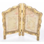 A late Victorian double photo frame Formed as a gilt decorated screen with foliate moulding and