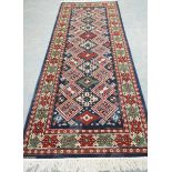 A Bokhara style runner The woven rectangular form rug embroidered Azerbaijan with central diamond
