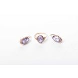 A synthetic colour change corundum ear pendant and ring suite The oval mix-cut corundum, claw set,