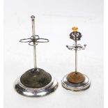 Two Silver hat pin stands To include a Silver based stand with thistle design with orange stone
