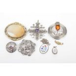 Two Scottish silver brooches Each set with an orange of purple stone,