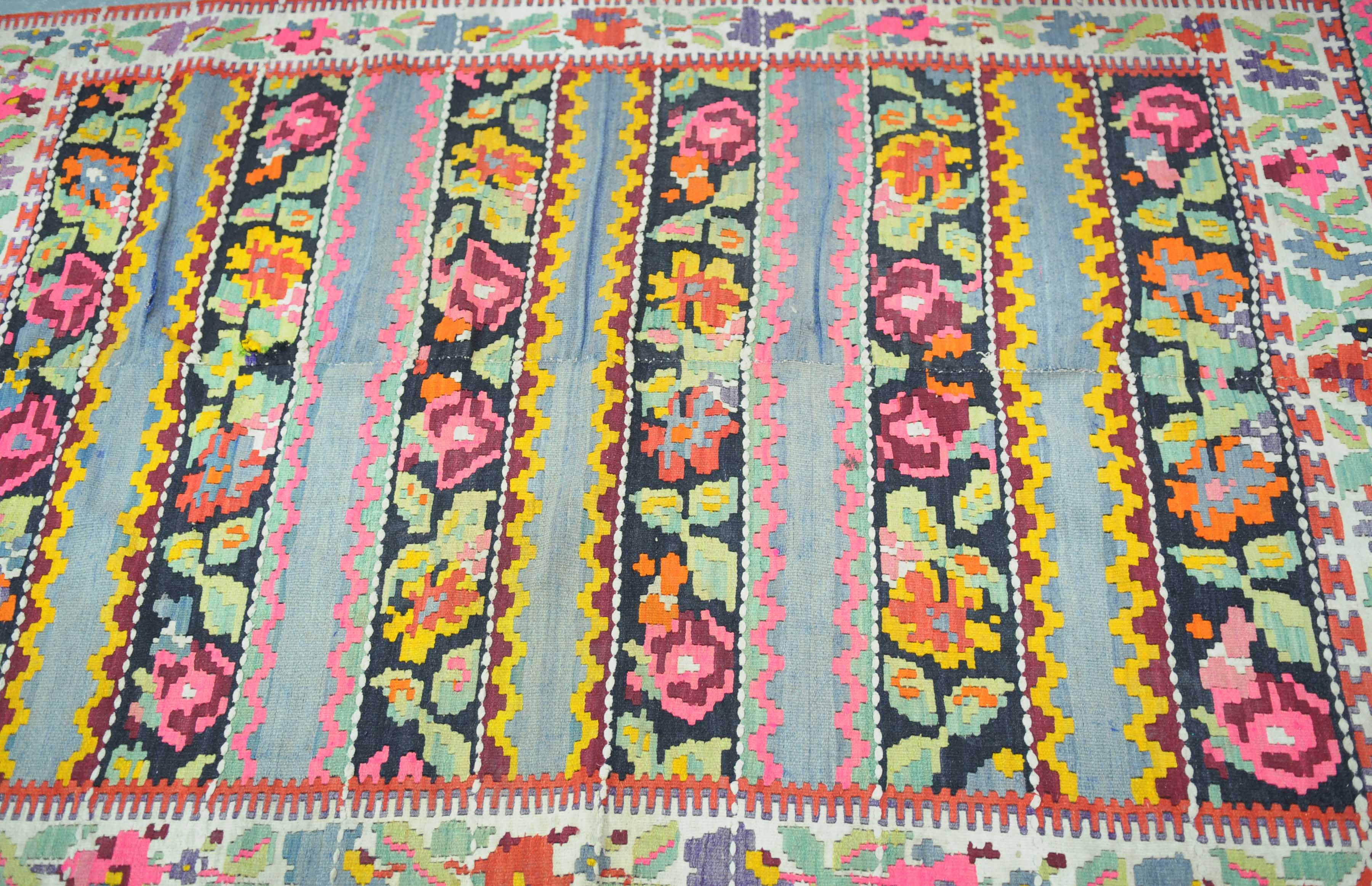 A Turkish Kilim style rug The flat woven rug with central horizontal panels detailed with abstract