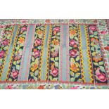 A Turkish Kilim style rug The flat woven rug with central horizontal panels detailed with abstract