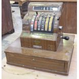 A vintage 1960's National cash register The wooden veneered till with various monetary dials and