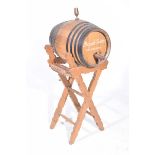 A 20th Century metal bound wooden sherry barrel On stained pine stand the barrel marked Delgardo