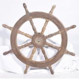A vintage carved wooden ships wheel Of circular form the turned eight spoke wheel adorned with