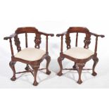A pair George III style mahogany corner chairs The outswept top rail with scroll terminals