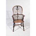 An early 19th Century elm and beech Windsor farmhouse elbow chair Having a central pierced splat