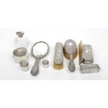 A collection of ladies silver backed dressing table items To include mirror, comb, hairbrush,