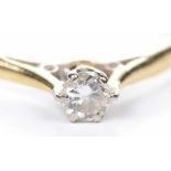A diamond single stone ring The round brilliant-cut diamond to a precious yellow metal shank,