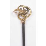 A Charles Horner Edwardian gold hat pin The top with 9ct gold lattice scroll design,