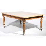 A 19th Century light oak dining table by Taylor of Edinburgh The rectangular thumb moulded top with