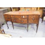 A late 18th / early 19th Century mahogany Serpentine sideboard Having two central graduated drawers