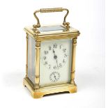 A late 19th Century French full glass brass carriage alarm clock The white enamelled dial with