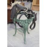 A green painted cast iron garden table Of typical classical tripod form,