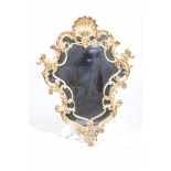 A gilt wood and gesso French rococo style wall mirror Of scalloped fan shape,