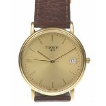 Tissot: A Gent's quartz wrist watch The circular gold dial with applied gold hour markers,