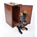 A Beck Ltd (London) microscope With black painted body and brass focusing wheels and lens,