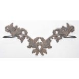 A late Victorian black painted cast iron wall stick stand Joined branches of oak leaf and acorns