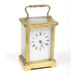 A French 19th Century four-glass brass carriage clock The corniche case adorned with reeded loop