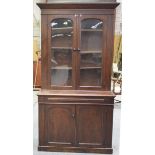 A Victorian mahogany library bookcase With a cavetto cornice above a pair of arched glazed doors