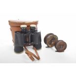 Two early 20th Century wooden fishing reels Each stained and applied with brass mounts,