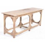 An industrial type stripped hardwood work or kitchen table With a rectangular plank top supported