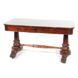 An impressive William IV rosewood library table The rectangular top with rounded corners above