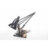 A 1950/60 Anglepoise lamp The black painted lamp with hinged arm, raised on a square stepped base.