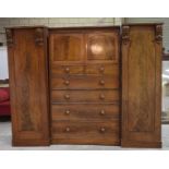 A Victorian mahogany compactum wardrobe The central section with a moulded cornice above two