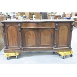 A Victorian mahogany serpentine sideboard Having a central serpentine frieze drawer over a pair of