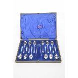 A Cased set of Edward VII Silver teaspoons and sugar tongs The black tealherette case enclosing