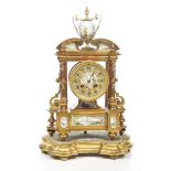 A late 19th Century French gilt metal porcelain and enamel decorated mantle clock With elaborate