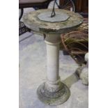A reconstituted stone sun dial Raised on a classical stepped pedestal,