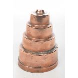 A Victorian copper jelly mould Of typical concentric stepped form, unstamped,