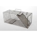 A vintage metal rat trap The galvanized metal basket with spring action trap and carry handle,