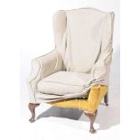 A Georgian style wing back fireside armchair,