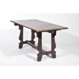 A mid 20th Century elm and oak refectory table The rectangular table top supported on shaped