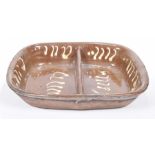 A 19th century English slipped ware dish The two division rounded rectangular form dish with